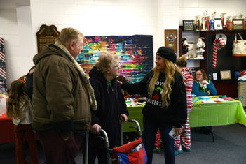 Three people conversing at an indoor event.