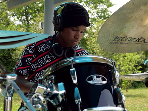 Keylin playing the drums at Pop-Up / Speak-Up