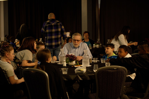 Third Grade Students Interviewing Trent at a table