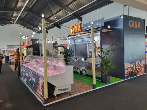Becketts display stand with displayed food products and airstream background graphics.