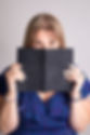 Sarah Bryer peering over an open book