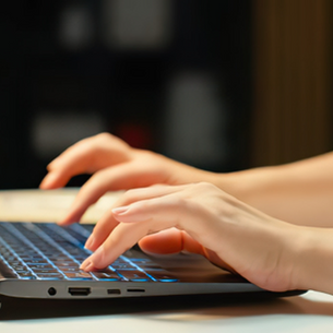 Typing on a laptop