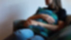 Lady sitting on a chair holding a cushion