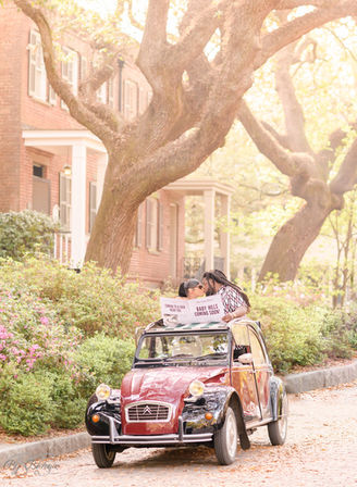 couple in vintage car baby announcement 