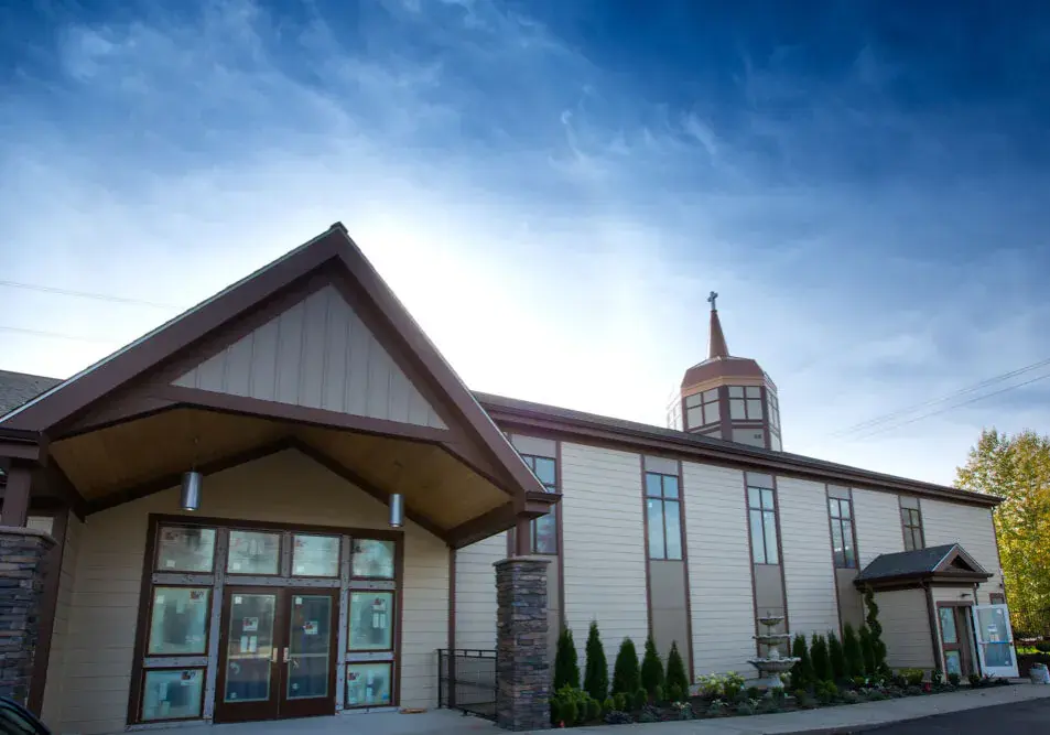 Landscape photo of Golgotha Baptist Church in Tacoma, WA, wide landscape with blue sky and church building centered.