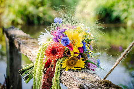 floral bouquet resting on wooden bridge