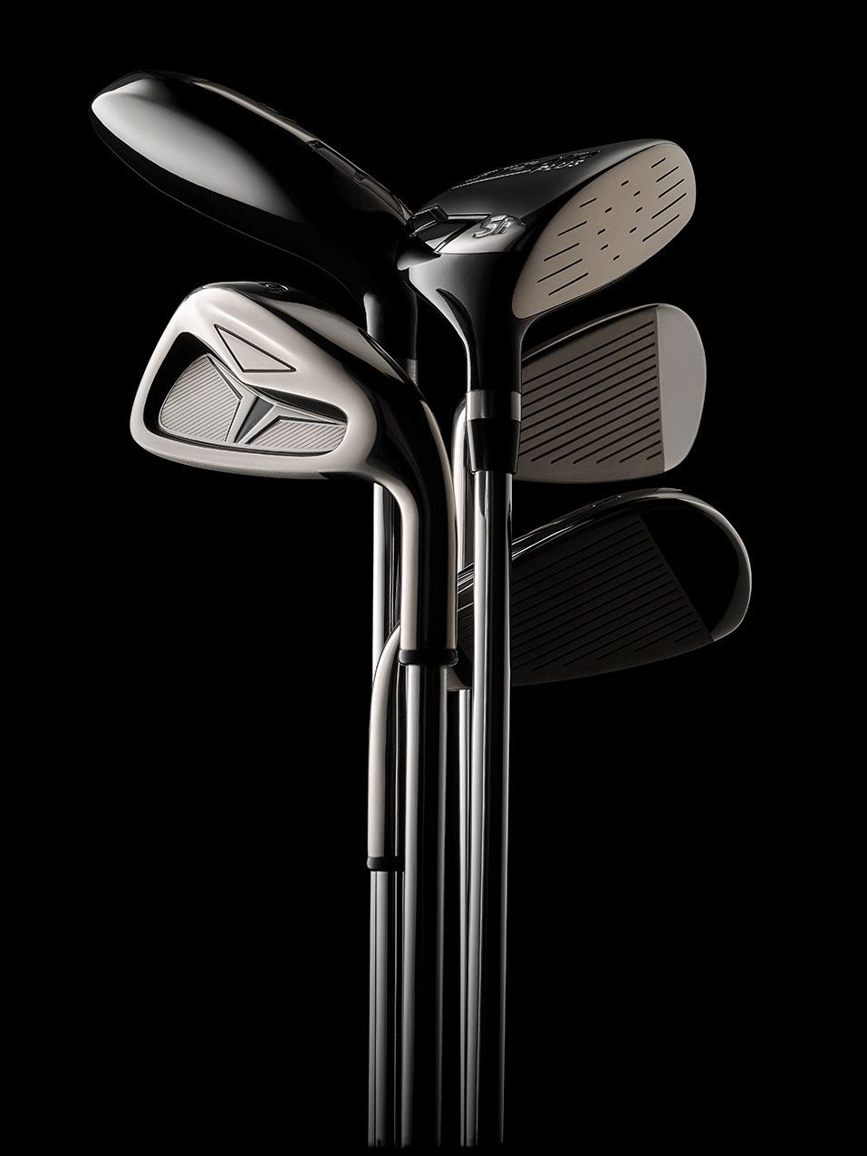 Multiple golf clubs with black background