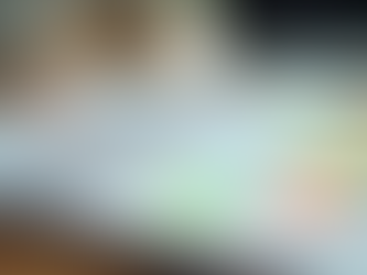 A detailed monthly planner with notes and a laptop on a wooden desk