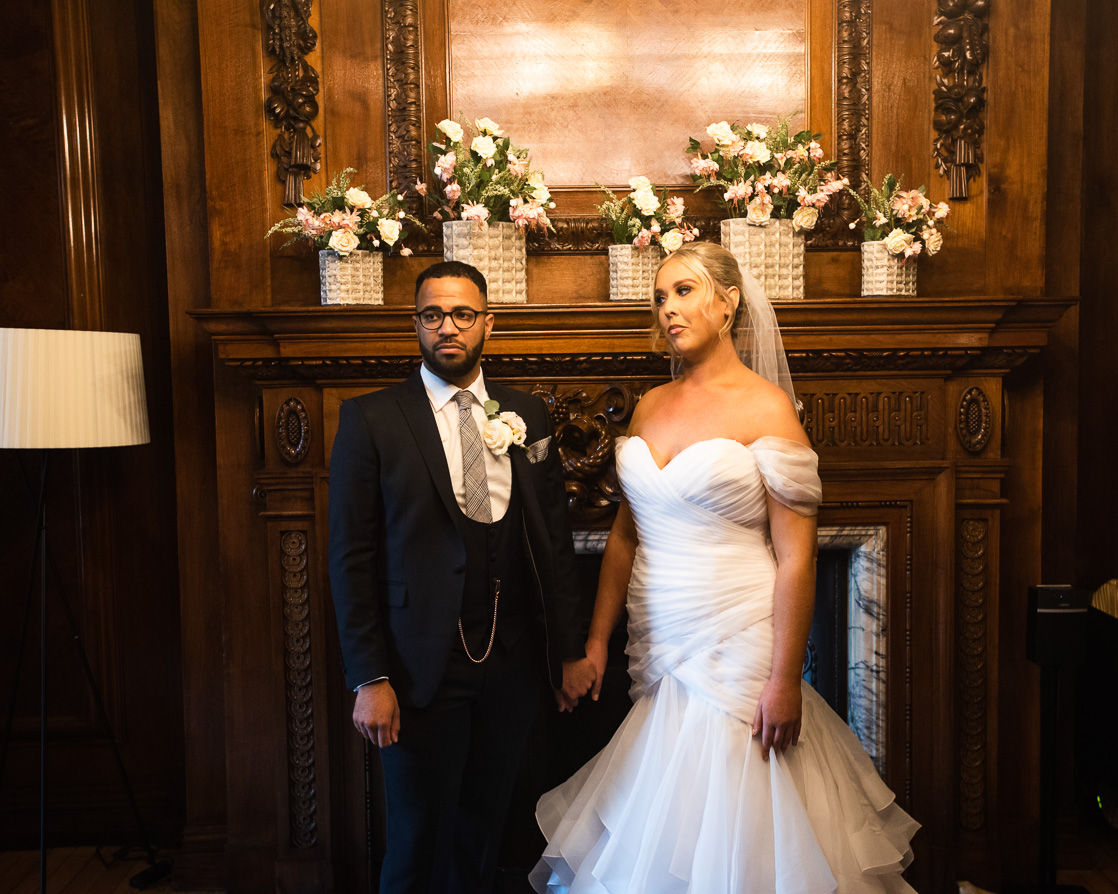 Happy couple poses for wedding photo at The Old Marylebone Town Hall.