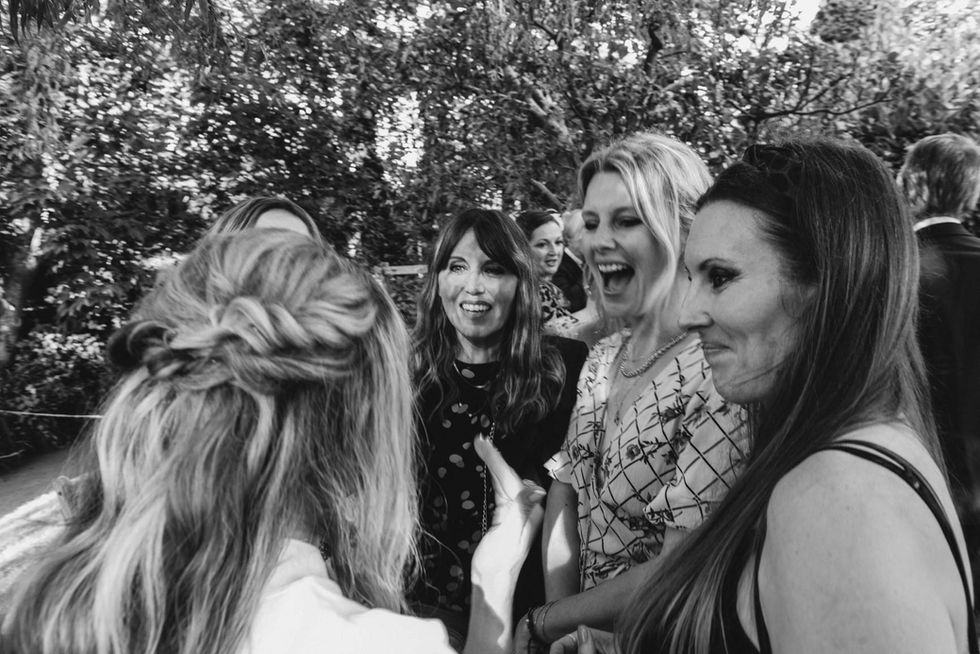 Happy wedding guests laughing together