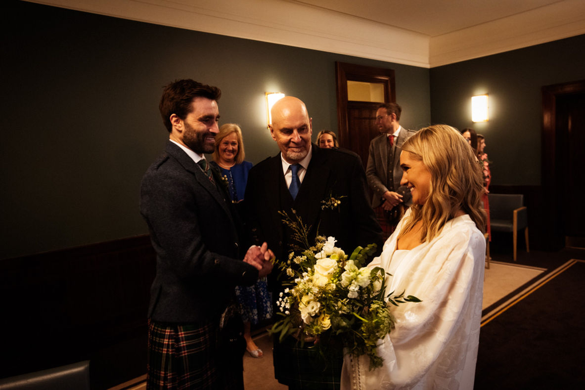 Happy couple with family after Scottish wedding ceremony