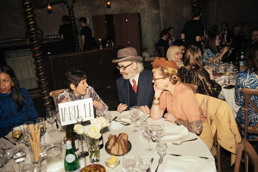 Guests at a table, 'Table 10', enjoying dinner party