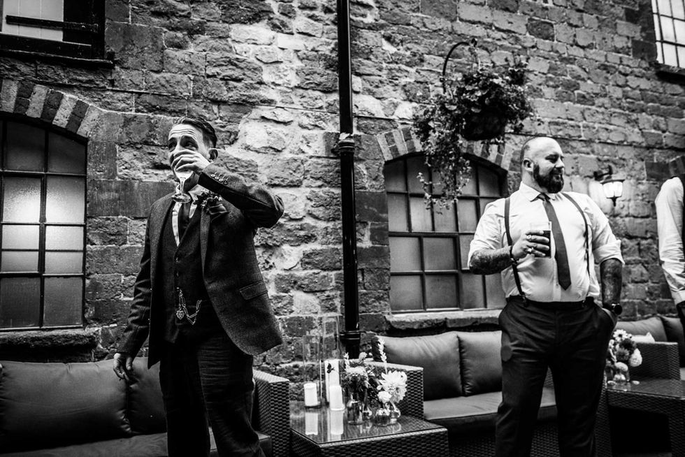 Groom toasting, wedding guests celebrate