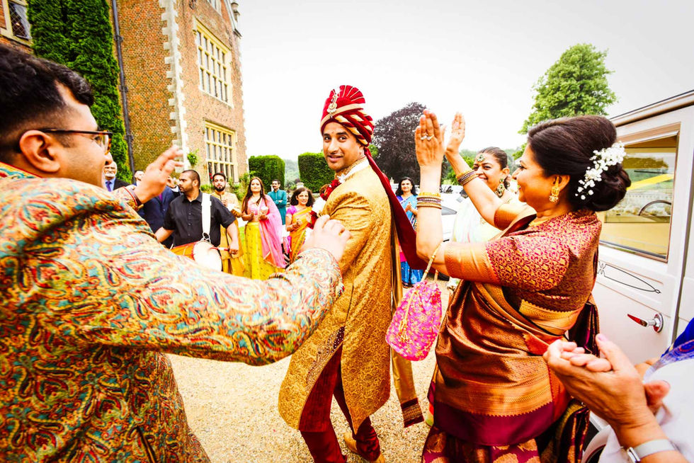 Groom joyfully dances with guests at North Mymms Hindu wedding