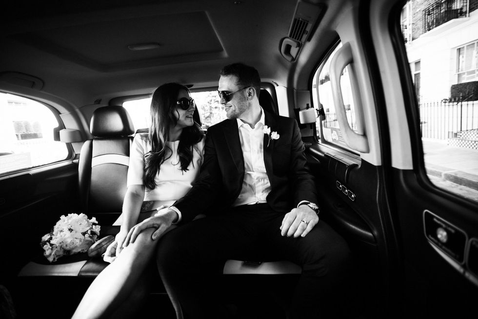 Happy couple in car after wedding