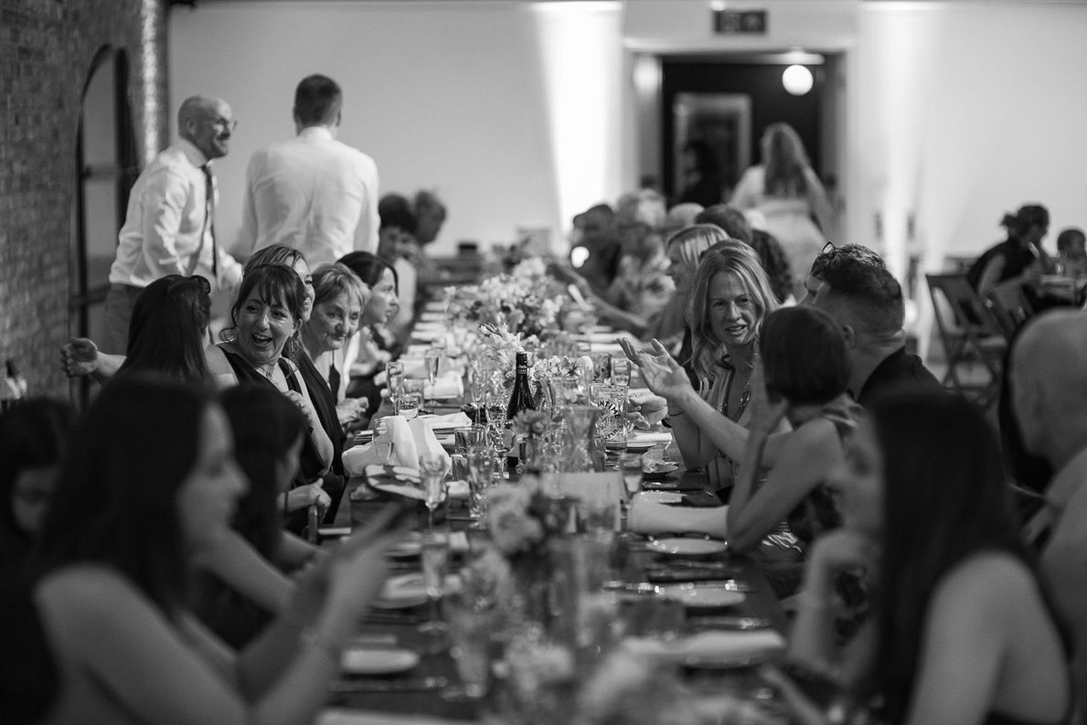 Guests enjoying a long wedding banquet table