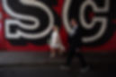 A stylish couple walking together toward  Hackney Town Hall for their documentary registry