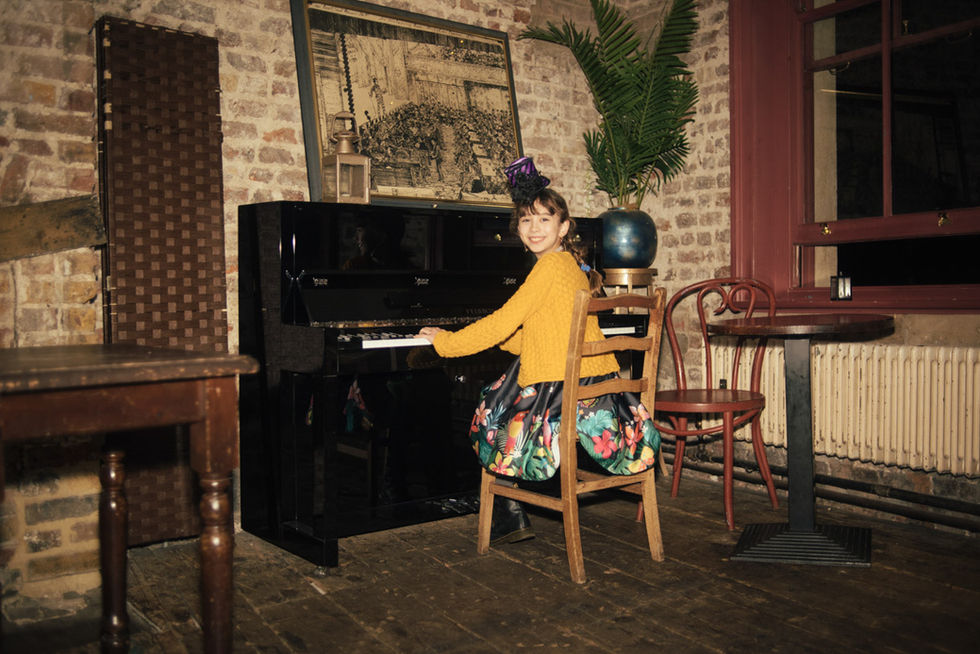 Girl playing piano in vintage room