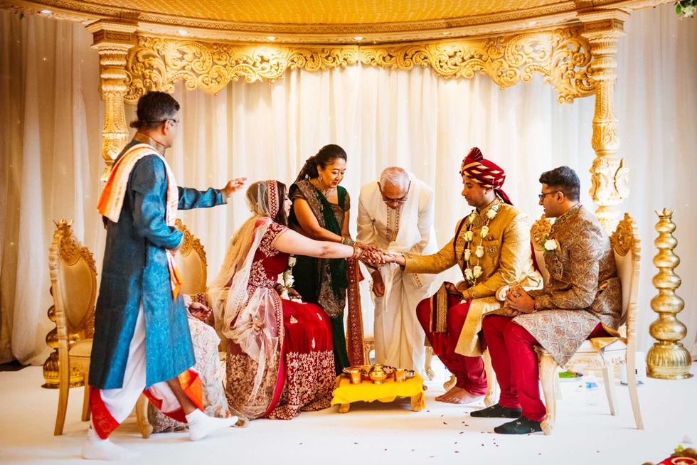 Hindu wedding ceremony: Bride and groom with family