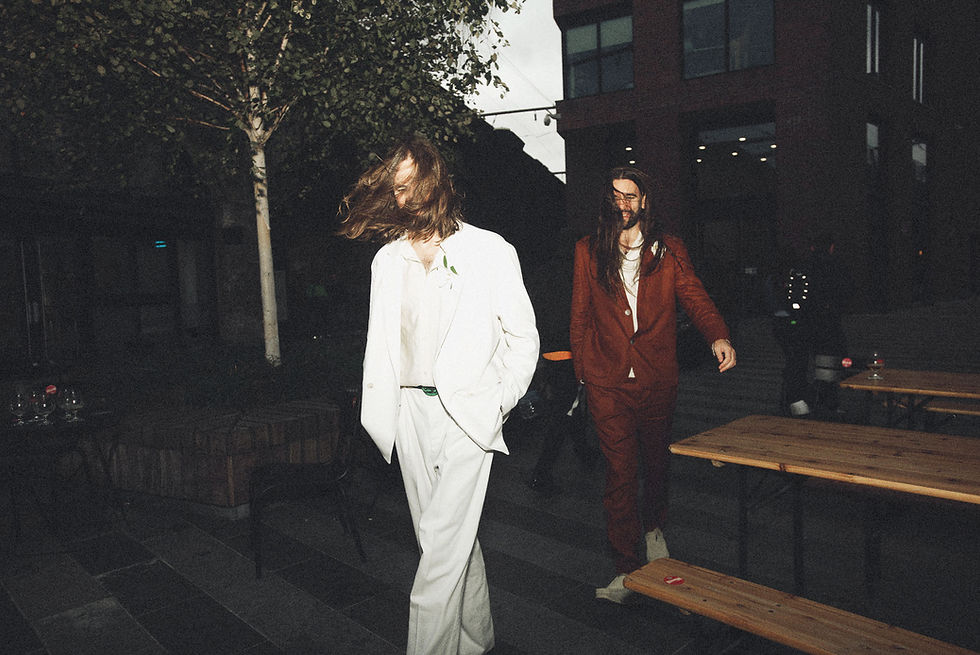 lgbtq-couple-dressed-70's-style.jpg