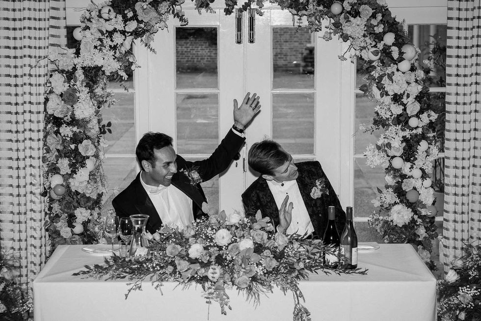 Happy gay couple at wedding reception