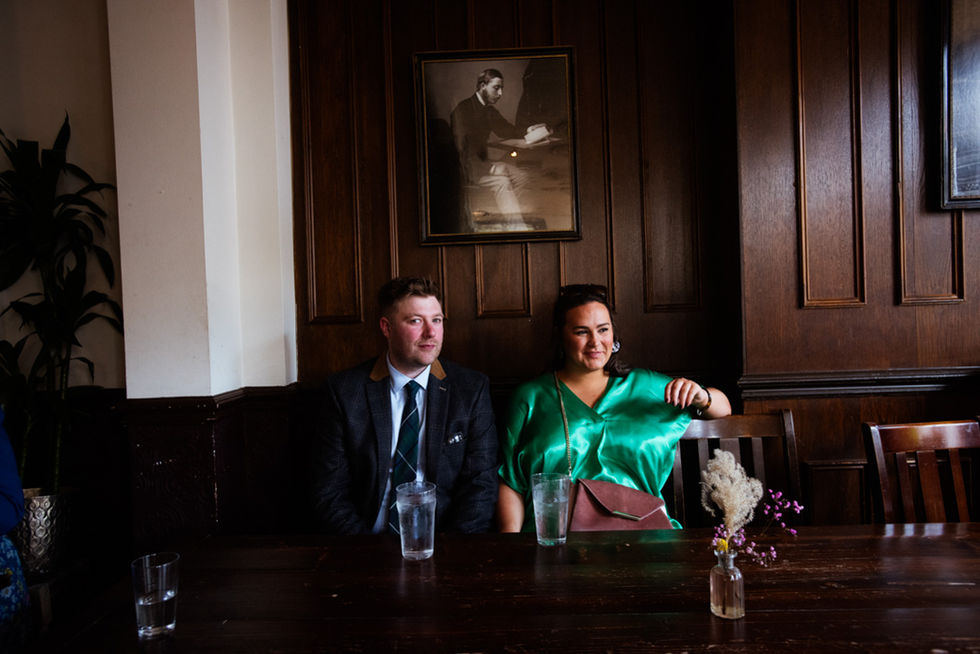 Happy couple seated at wedding reception table
