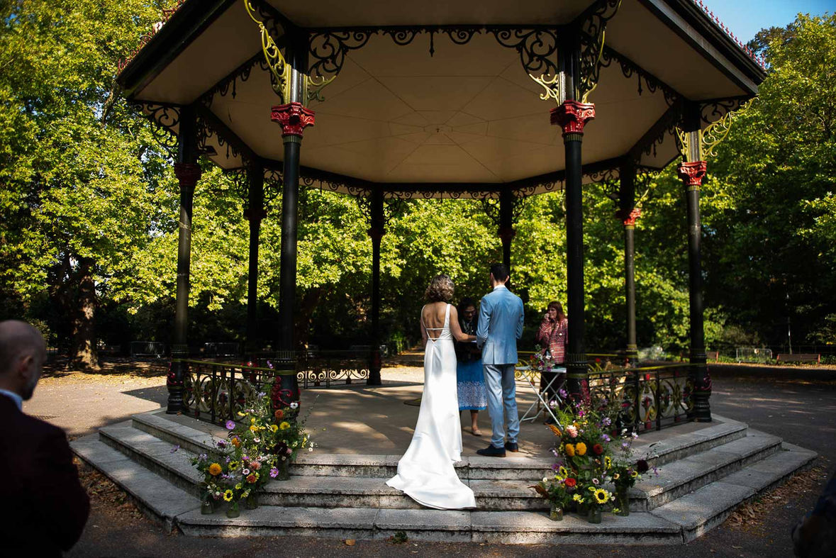 Couple exchanging vows in Battersea Park bandstand