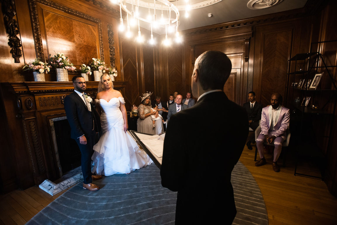 Couple exchanging vows, wedding ceremony at Marylebone Town Hall