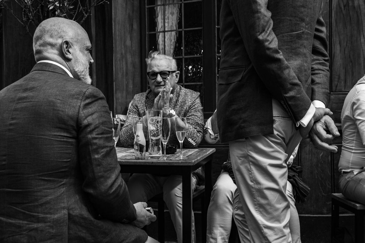 Men in suits enjoying champagne at a table