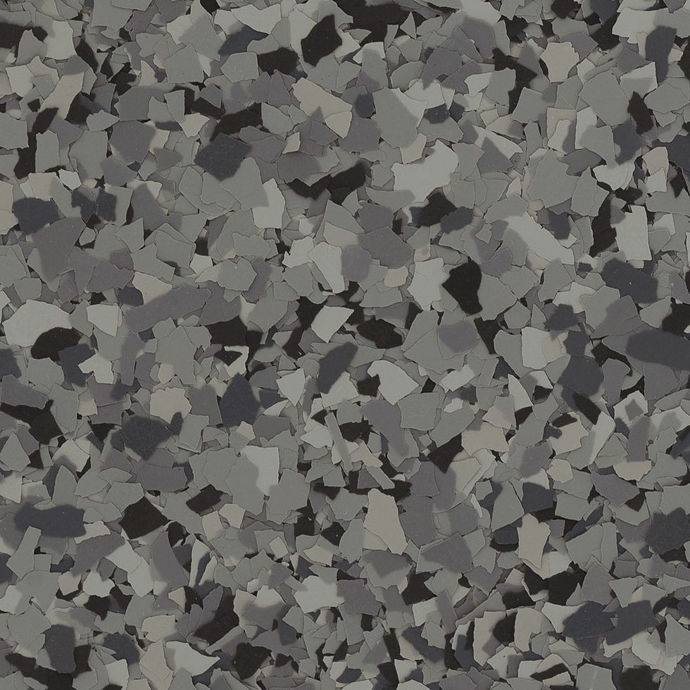 A close-up of a speckled vinyl flake floor with irregular black, white, and grey patterns resembling scattered stone chips.