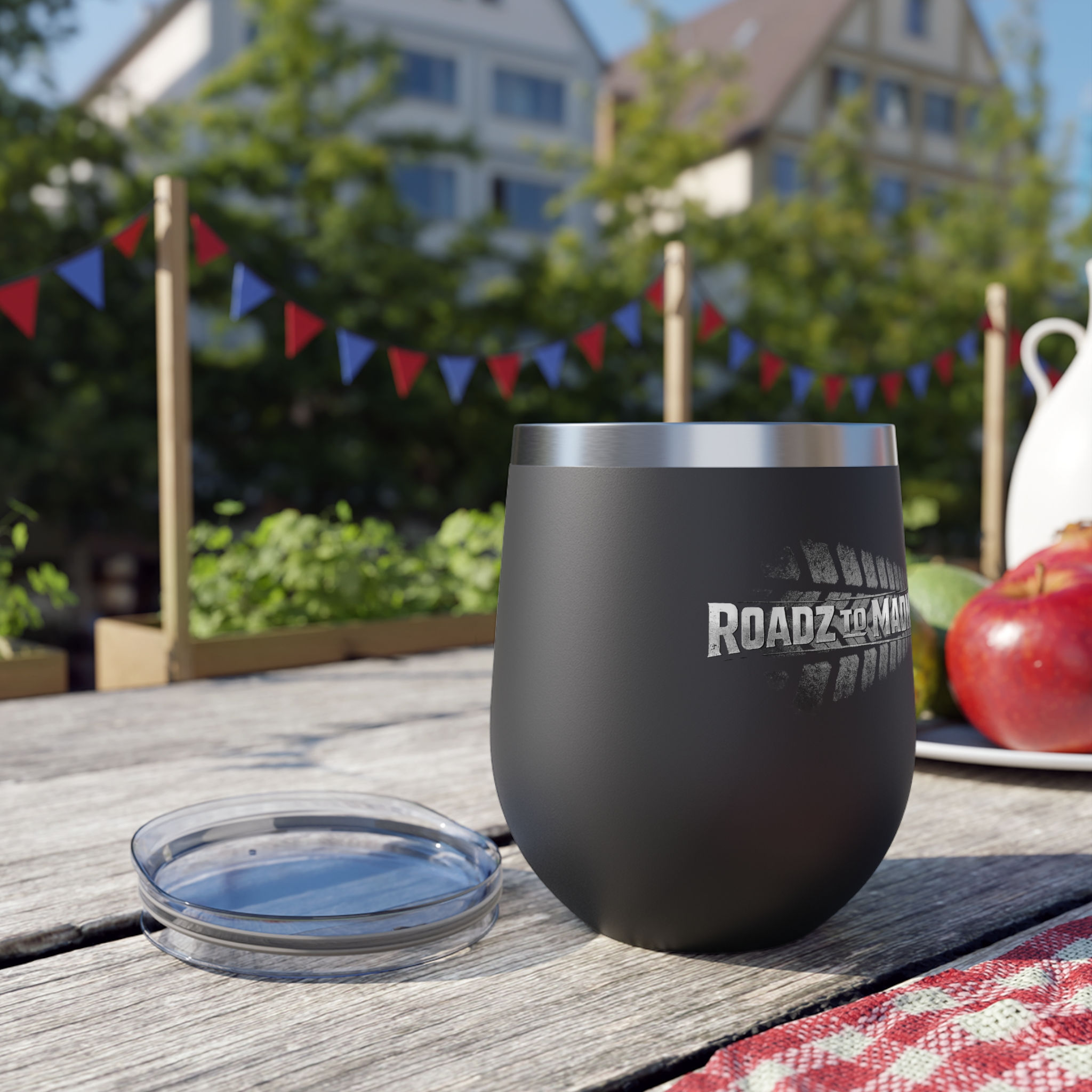 Black Roadmate tumbler with lid on a picnic table