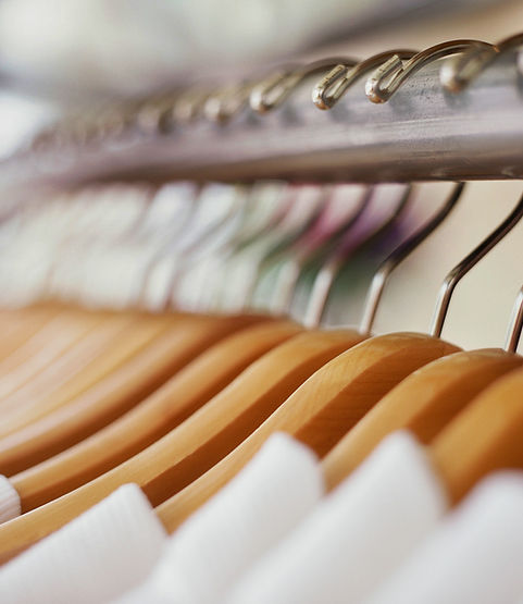 row on wooden hangers on a rail