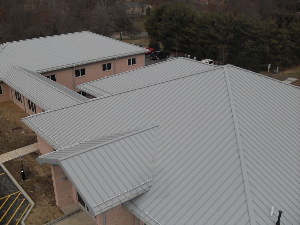 Completed standing seam metal roof installed on a commercial building by Schultheis Roofing.