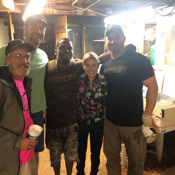 Pro golfer visiting The Crawdad Hole with staff. Lakeland Drive Cajun seafood restaurant in Jackson, MS.