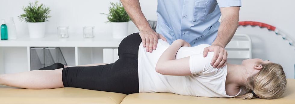 A chiropractor in Pittsburgh performs a chiropractic adjustment to relieve the patient's lower back pain.