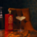 Bullion cherry spiced rum next to cocktail glass