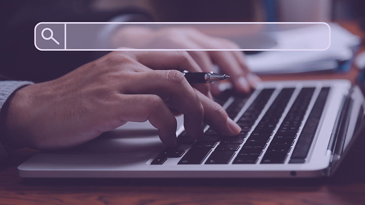 Hands typing on a laptop keyboard with a search engine bar overlay. Website traffic strategies.