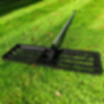 lawn lute for levelling soil on striped grass