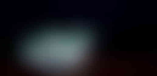 a service station glows in the foggy night