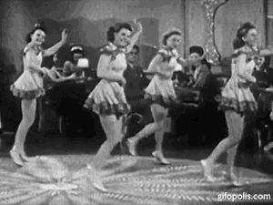 This is a black and white animated gif from the 1947 film, Variety Girls. It shows five young woman dancing with their left arm raised.