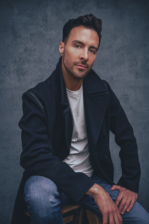 male actor headshot Vancouver with dark jacket seated pose studio portrait