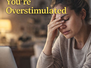 A woman sitting in front of her computer with her head in her hands. Eyes closed from exhaustion.
