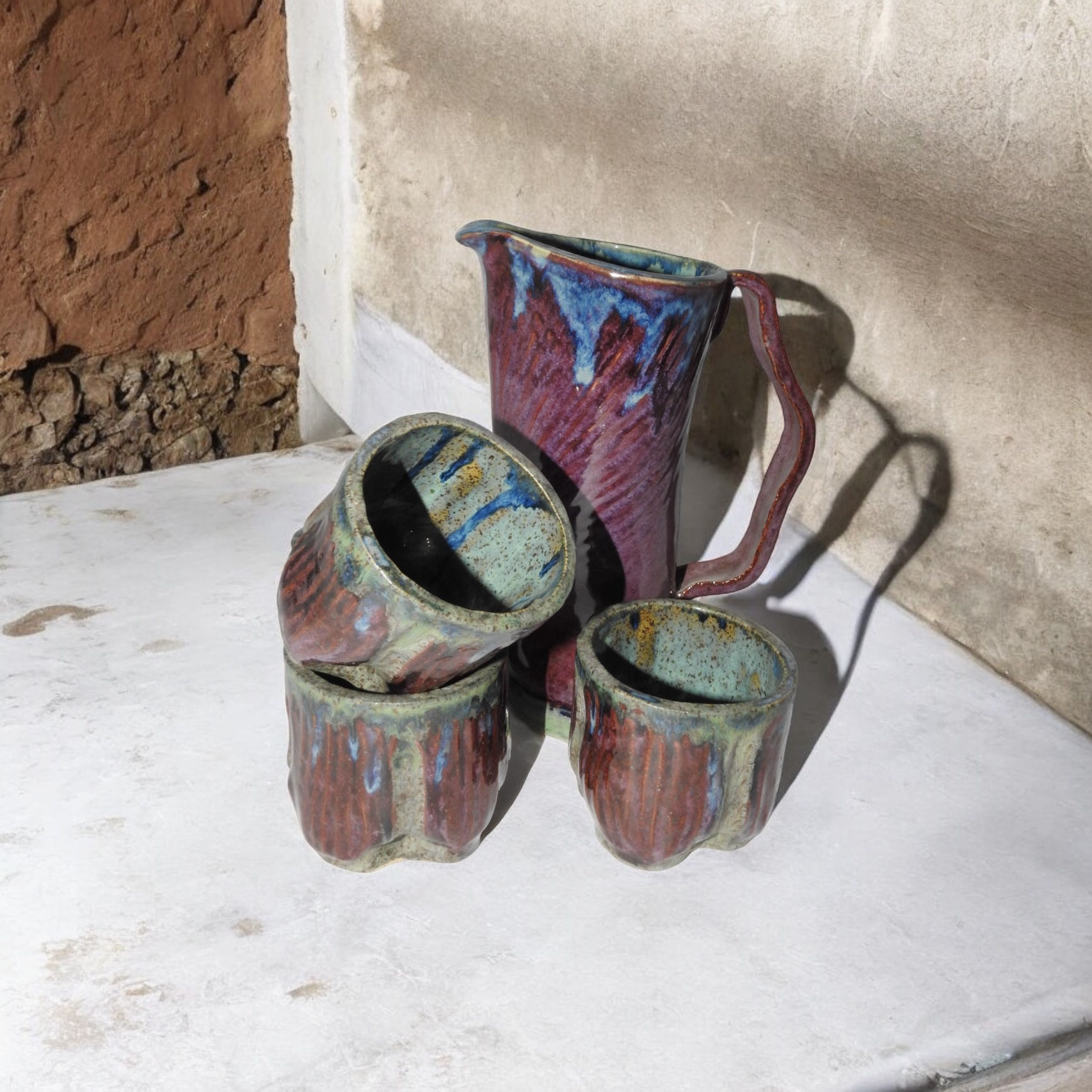 Pitcher with three mugs
