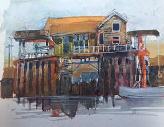 House on stilts next to an estuary