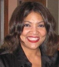 Smiling woman with long wavy brown hair and red lipstick