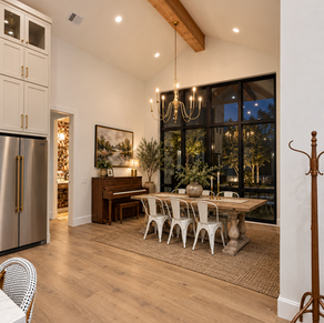 Dining room with tall black windows and chandelier in a Burnet custom home