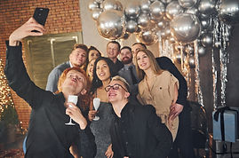 vecteezy_man-taking-selfie-of-his-friends-that-standing-in-christmas_15249316.jpg