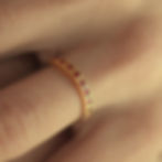 Close-up of ROSEANNE - Ruby-Encrusted Gold Ring showcasing the detailed gold decorations and vibrant rubies.