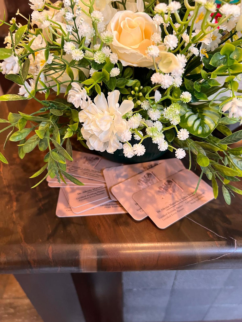 a stack of business cards sits on a table next to a bouquet of flowers