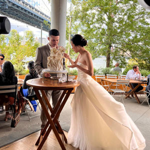 a bride and groom are cutting their wedding cake